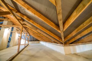 Attic of a building with wooden beams of a roof structure.
